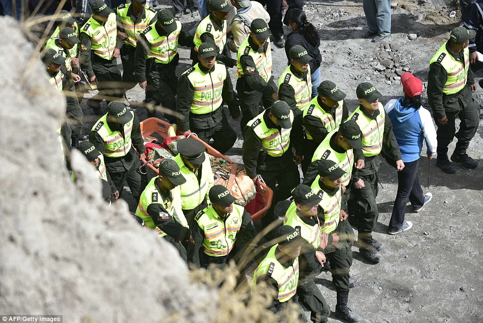 Rescuers carry a victim of a landslide caused by the earthquake