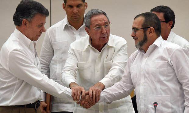 Raul Castro seals the handshake between the head of the FARC, Timochenko, and the Colombian President, Juan Manuel Santos. Photo (c) The Guardian 2016