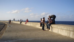 A system of blackmarket internet access has grown from users’ frustration with lacking international connectivity. (Photo: People gathered at what is now a landmark wifi spot, Malecón, Miami in the far distance behind them).
